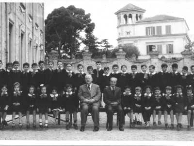 Ci� che mostra anche una foto del 72enne Nico Velluso, alunno della prima elementare nell�anno scolastico 1955-1956. Nell�immagine notiamo il gruppo composto da oltre 30 alunni, assieme all�insegnante e al rettore. Alle loro spalle si scorge il torrino dell�antica Villa Camomilla, abbattuta anni dopo
